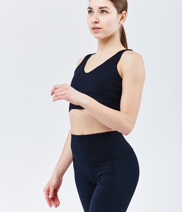 Woman in a dynamic yoga flow pose, feeling energized and focused.